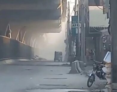 FC headquarters in Peshawar with smoke rising after suicide blasts and heavy gunfire by attackers