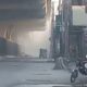 FC headquarters in Peshawar with smoke rising after suicide blasts and heavy gunfire by attackers