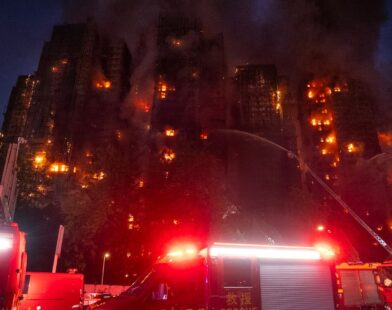 Smoke rising from high-rise buildings in Hong Kong after a massive fire with rescue teams at the scene