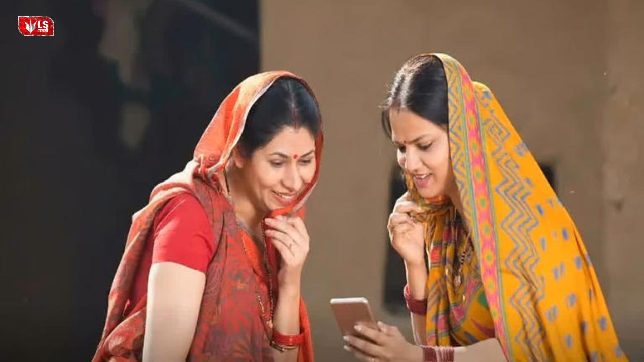 Two rural women smiling while checking scheme benefits on a mobile phone under the Ladki Bahin Yojana