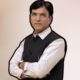 Union Labour Minister Mansukh Mandaviya standing and addressing the media