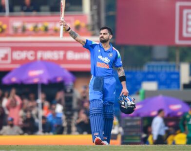 Virat Kohli celebrating after scoring a record-breaking century in the Ranchi ODI, achieving multiple cricket records