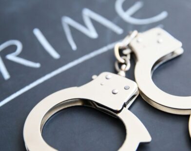 Crime text with handcuffs placed on the side symbolizing burglary and vehicle theft