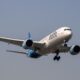IndiGo aircraft grounded at the airport with large crowds of stranded passengers due to mass flight cancellations