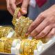 Silver bars and gold coins representing the latest record-breaking price surge