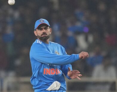 Virat Kohli standing on the cricket ground after India’s victory against South Africa, looking confident