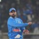 Virat Kohli standing on the cricket ground after India’s victory against South Africa, looking confident