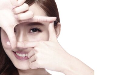 Woman applying eye cream during winter for dry eye prevention and healthy eyes