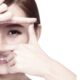 Woman applying eye cream during winter for dry eye prevention and healthy eyes